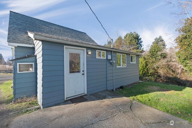 view of outbuilding featuring a yard