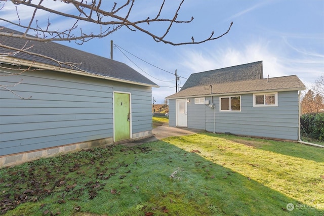 rear view of property with a lawn