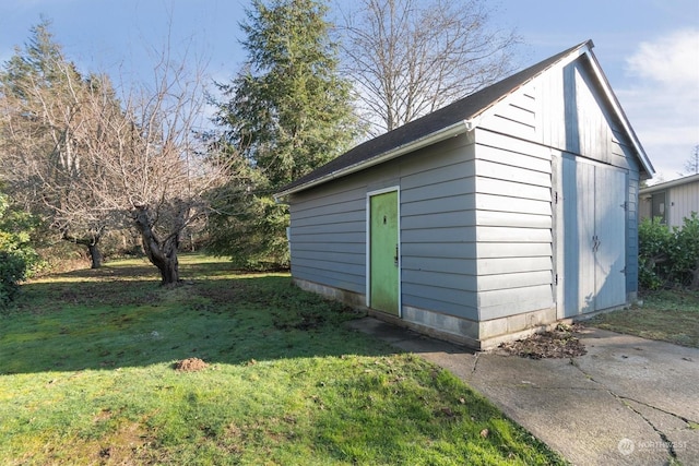 view of outbuilding featuring a yard