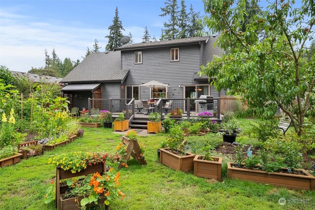 back of house with a wooden deck and a yard