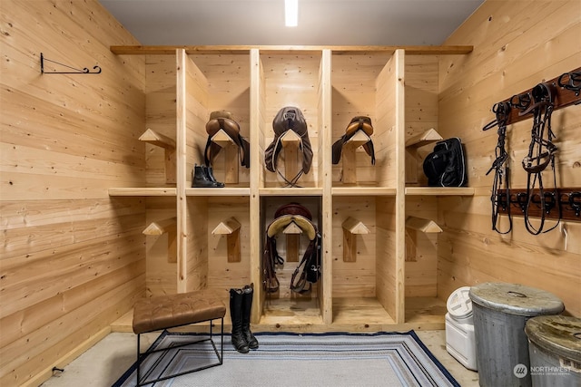 mudroom featuring wooden walls