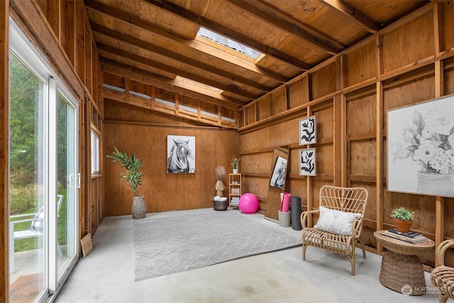 interior space with a skylight and wooden walls