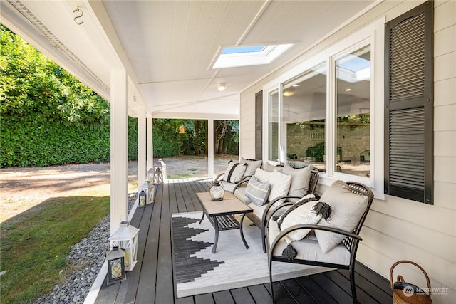 wooden terrace with an outdoor hangout area