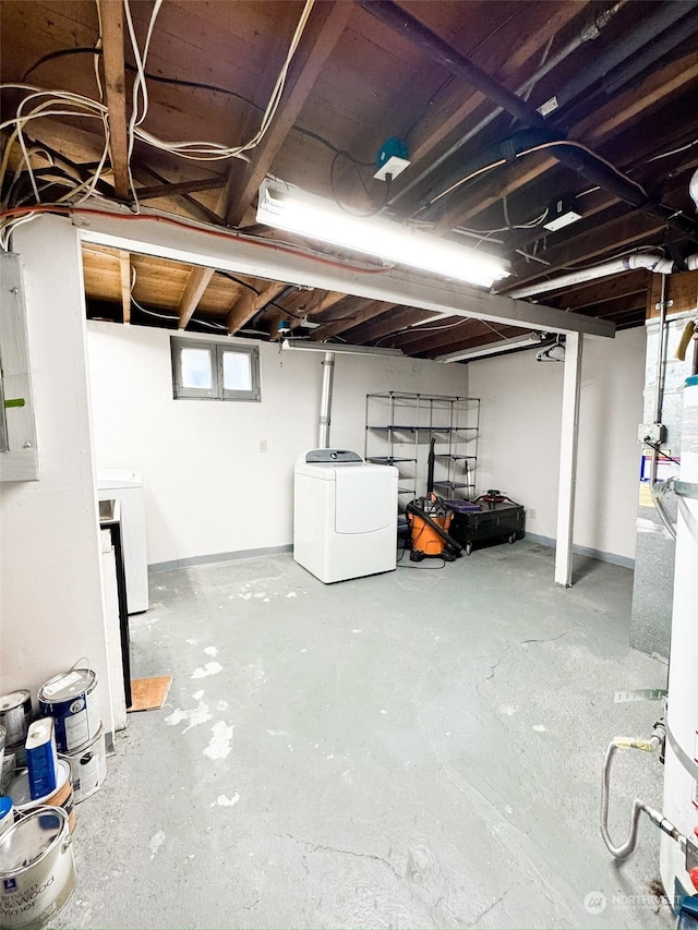 basement featuring electric panel and washing machine and clothes dryer