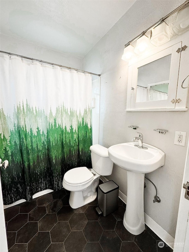 bathroom featuring toilet and walk in shower