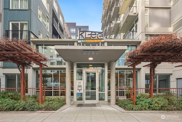 entrance to property featuring a pergola