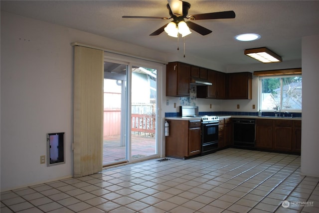 kitchen featuring dishwasher, electric range oven, light tile patterned flooring, and a healthy amount of sunlight