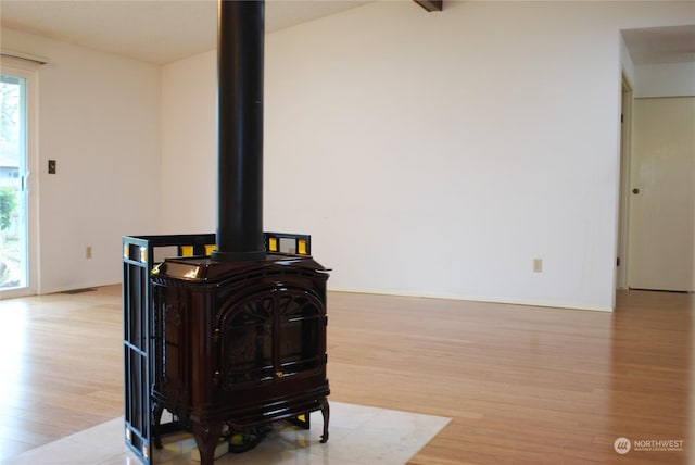 room details featuring hardwood / wood-style flooring and a wood stove