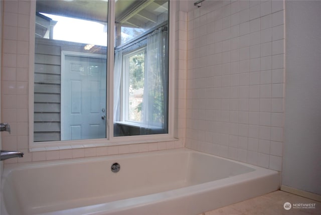 bathroom with tile patterned floors and  shower combination