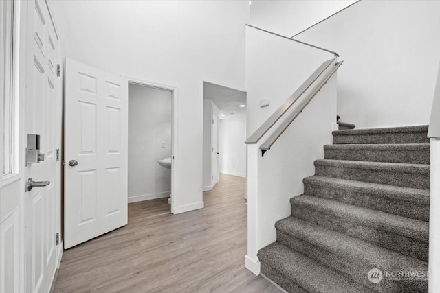 stairs featuring hardwood / wood-style floors