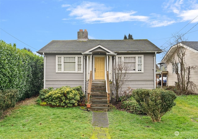 bungalow-style house with a front lawn