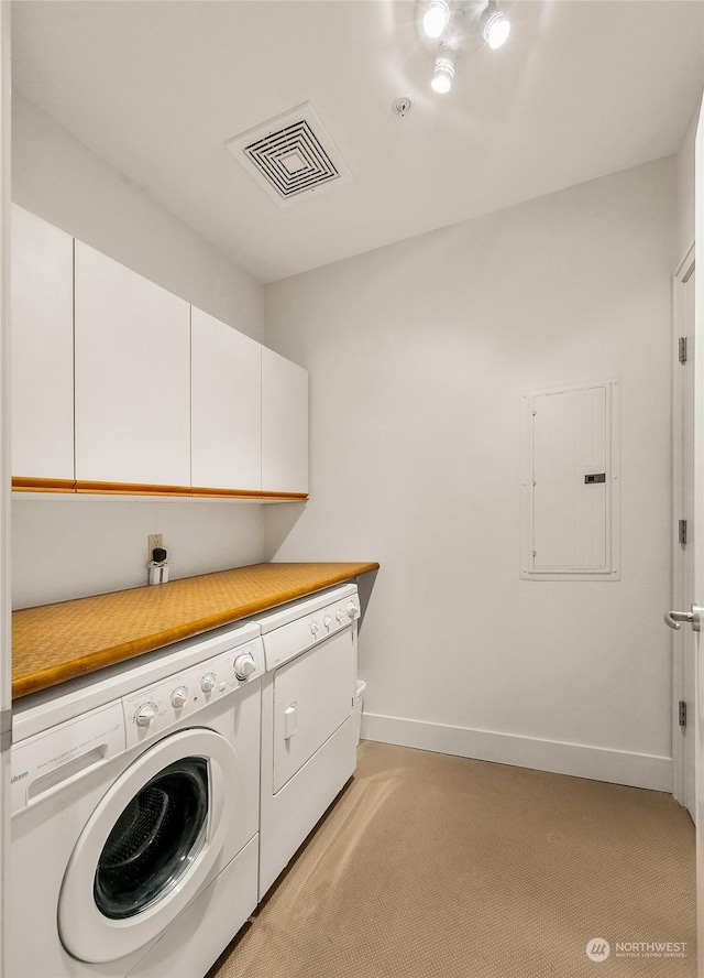 clothes washing area with independent washer and dryer, cabinets, electric panel, and light colored carpet