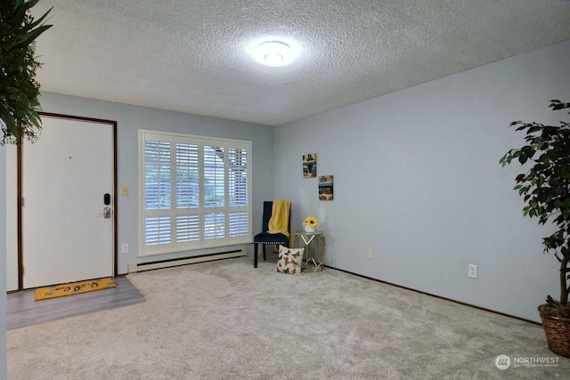 interior space featuring a textured ceiling and a baseboard heating unit