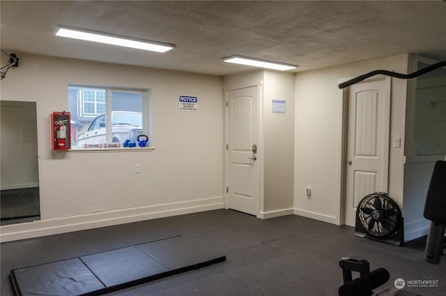 exercise room with a textured ceiling