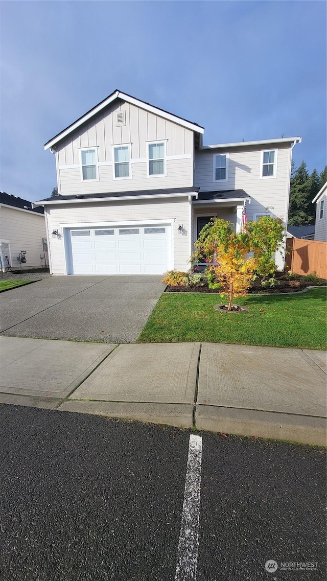 front facade featuring a garage and a front yard