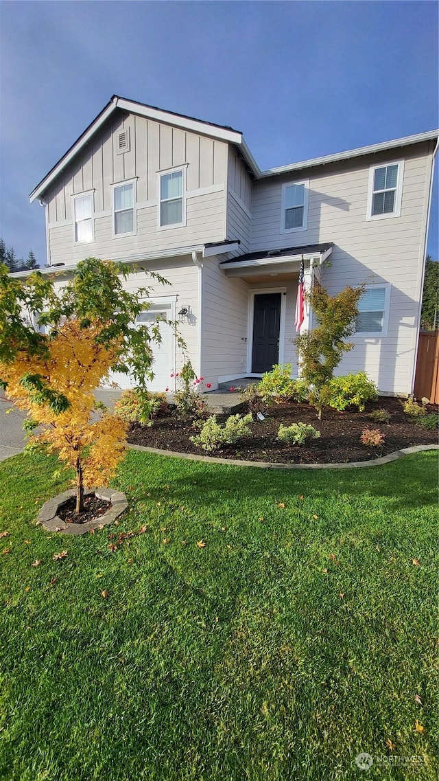 view of front of house featuring a garage and a front lawn