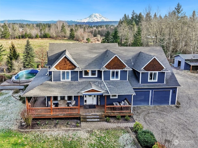 view of front facade featuring a deck with mountain view