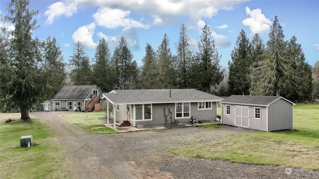 view of front of property with a shed and a front yard