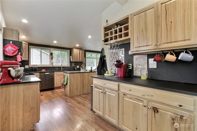 kitchen with decorative backsplash, a center island, light wood-type flooring, dishwasher, and sink