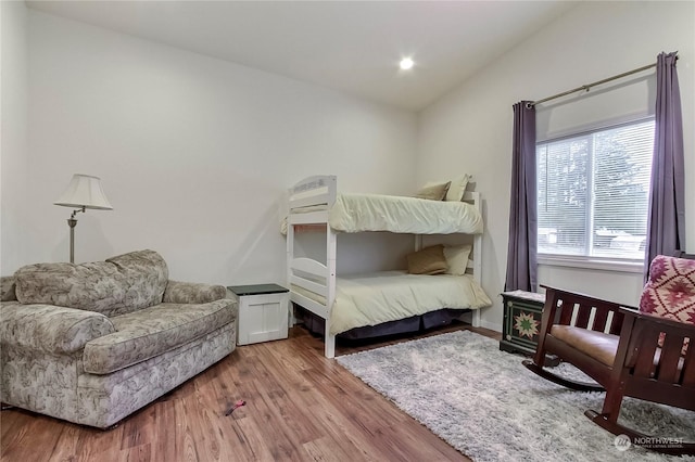 bedroom featuring lofted ceiling and hardwood / wood-style flooring