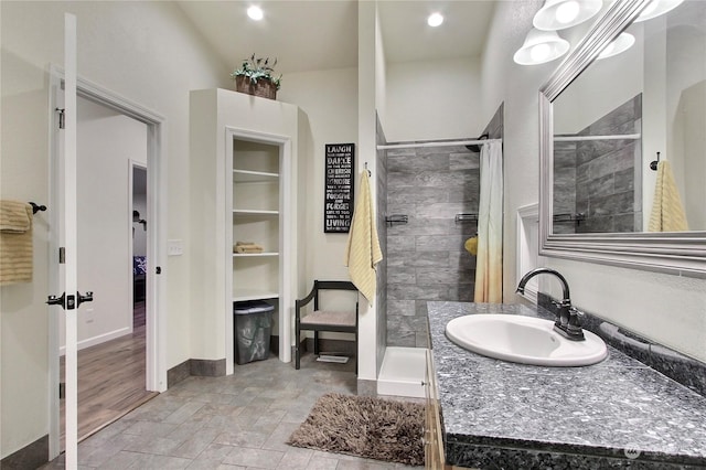 bathroom with a shower and vanity