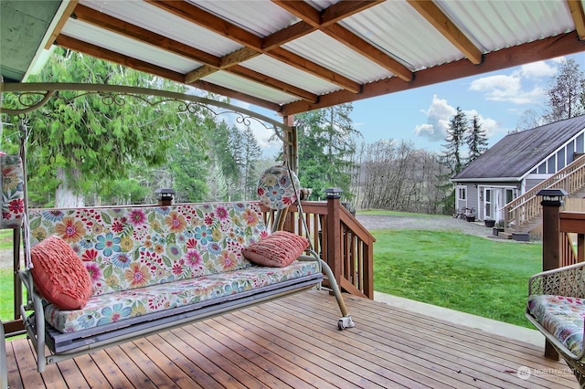 wooden deck with an outbuilding and a lawn