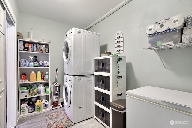 washroom featuring stacked washer and clothes dryer