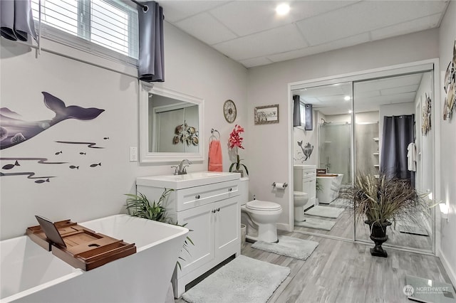 full bathroom with toilet, hardwood / wood-style floors, a paneled ceiling, shower with separate bathtub, and vanity