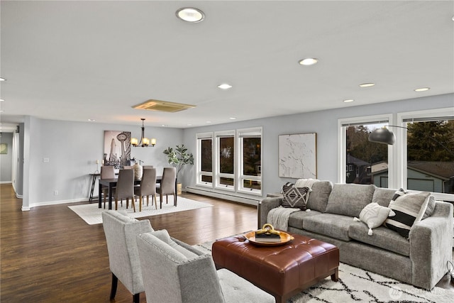 living room with a baseboard radiator, baseboards, wood finished floors, and recessed lighting