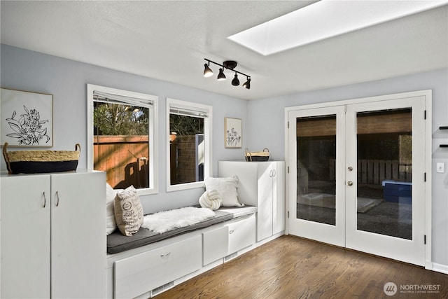 mudroom with a skylight, dark wood-style flooring, and french doors