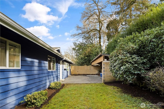 view of yard featuring fence and a patio