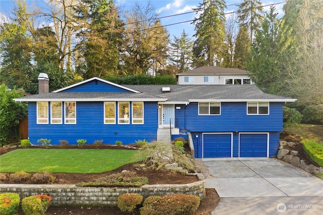 view of front facade with roof with shingles, a chimney, an attached garage, a front yard, and driveway