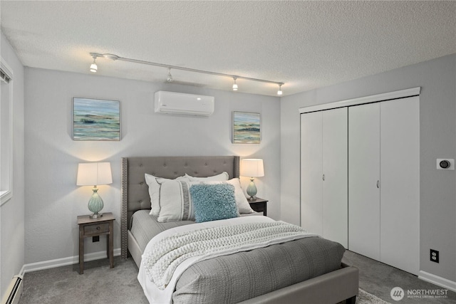 bedroom featuring a textured ceiling, a baseboard heating unit, carpet flooring, and a wall mounted AC