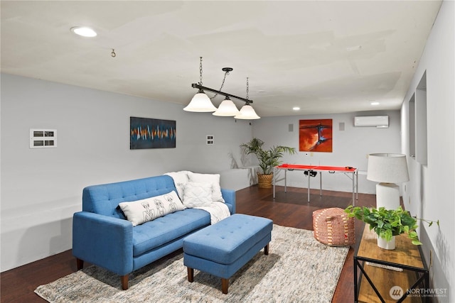 living area featuring recessed lighting, a wall mounted air conditioner, and wood finished floors