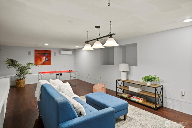 living room featuring a wall mounted AC, wood finished floors, and recessed lighting