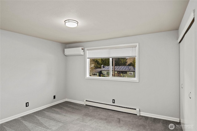 unfurnished bedroom with carpet, a wall unit AC, a closet, a baseboard heating unit, and baseboards