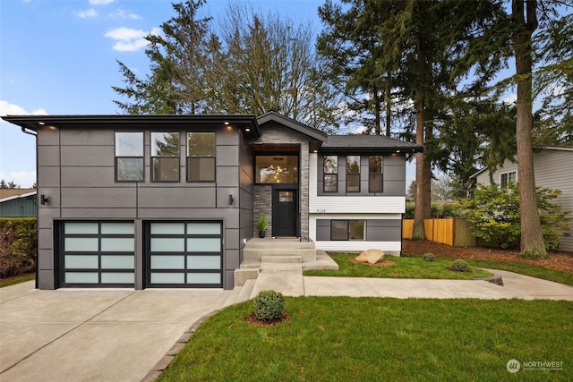 view of front of property with a front yard and a garage