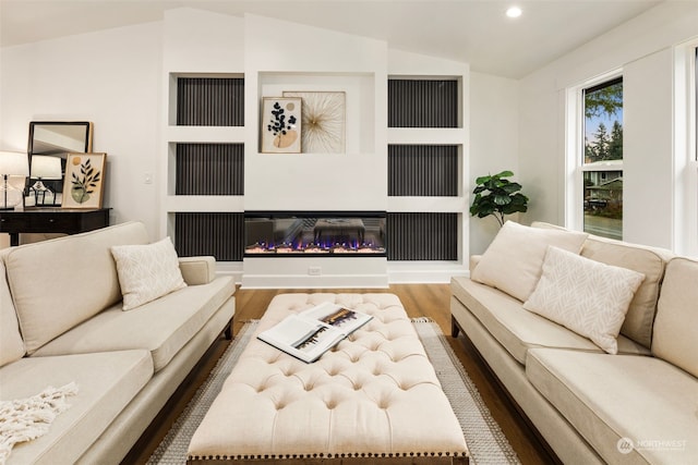 living room featuring hardwood / wood-style floors and vaulted ceiling