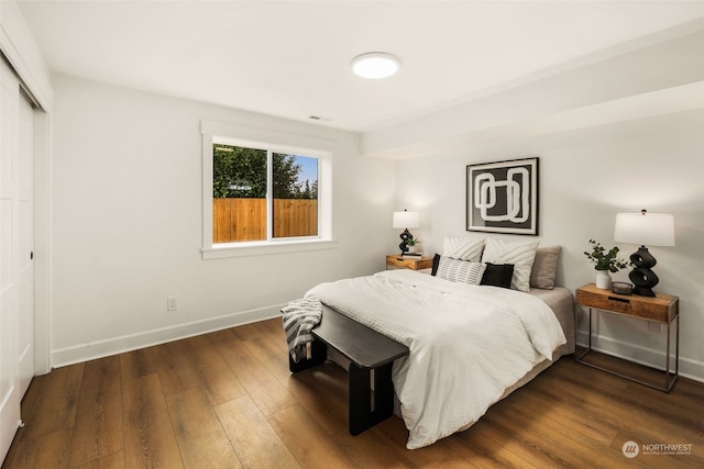 bedroom with dark wood-type flooring