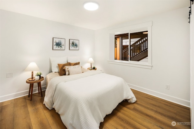 bedroom with hardwood / wood-style floors