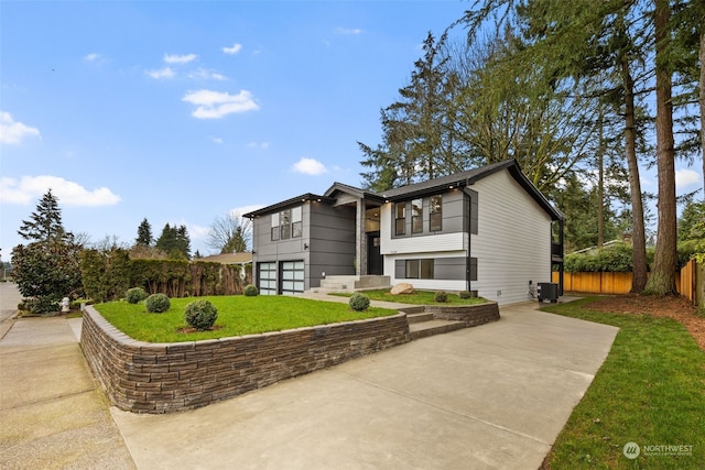 view of front facade with central AC unit, a front yard, and a patio