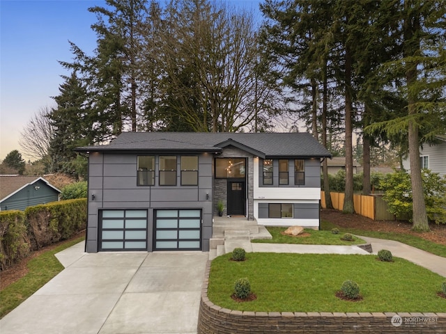 view of front facade featuring a lawn and a garage