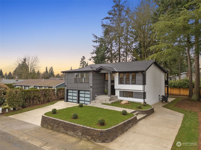 view of front of home featuring a lawn and a garage