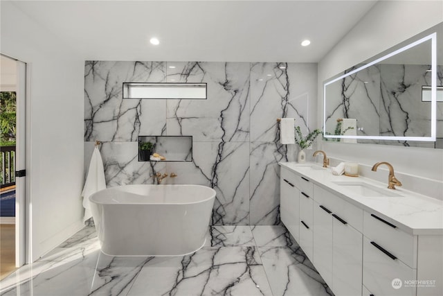 bathroom featuring a washtub and vanity