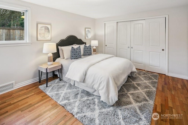 bedroom with a closet and hardwood / wood-style floors