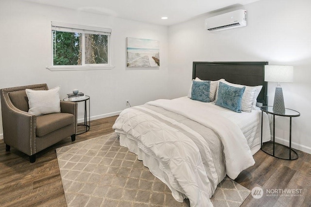 bedroom featuring wood-type flooring and a wall mounted air conditioner