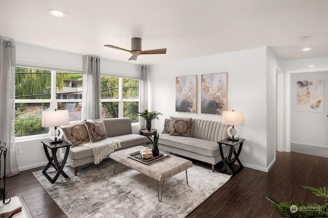 living room featuring dark wood-type flooring, a wealth of natural light, and ceiling fan