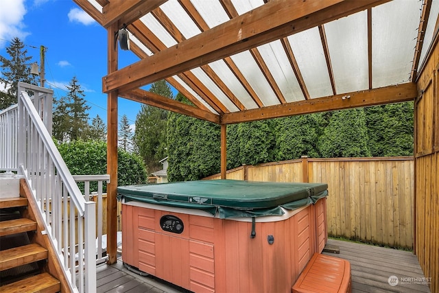 wooden terrace featuring a hot tub