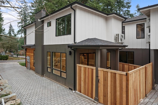 rear view of property with ac unit