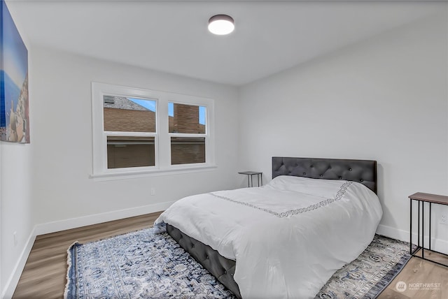 bedroom with hardwood / wood-style flooring